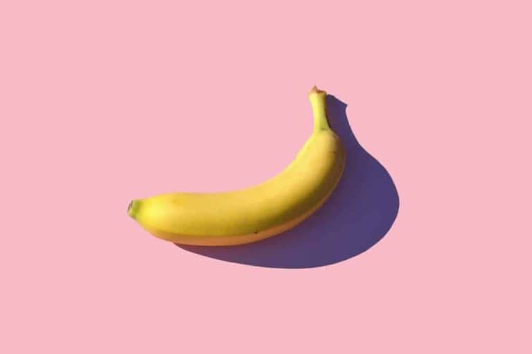 Fresh banana on pink background, bright produce, healthy snack option.